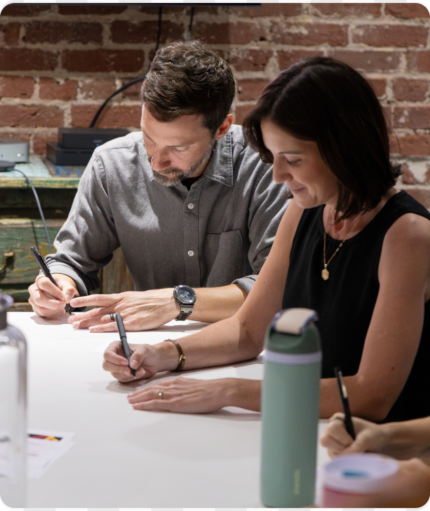 A man and a woman working at a desk