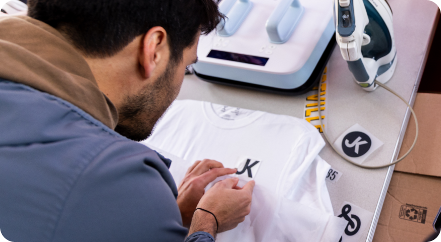 The back of a man working on a t-shirt